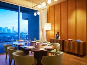 One Avighna Park Lower Parel 5 BHK Dining Area With Round Table Chairs And Pendant Lights