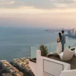 Prestige Ocean Towers Couple Viewing Marine Drive Seashore from Terrace