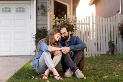 Couple in Love sitting on lawn of their second home