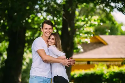 Couple Standing in Front of their Front Home Tree