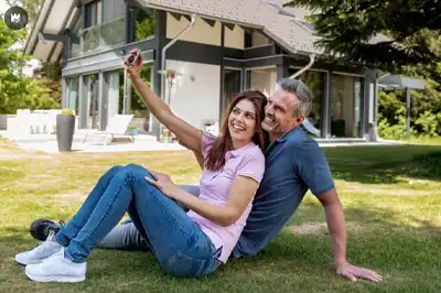 Couple Taking Selfie on Lawn of Their Holiday Home