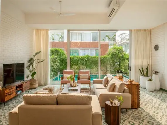 La Sierra Vagator Villa 3 BHK Living Room With Sofa Facing Pool