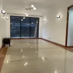 3.5 BHK Windermere Andheri West Living Room With Polished Floor And Balcony Doors