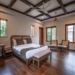 4 BHK Villa Agarsure Alibaug Bedroom With Bed And Two Chairs