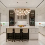 Purva Clermont Chembur Kitchen With Central Island Three Bar Stools Cabinets Built In Oven And Sink