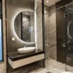 Purva Clermont Chembur Bathroom With Wash Basin Round Mirror Glass Shower And Wall Tiles