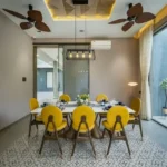 6 BHK Villa Awas Alibaug Dining Room Yellow Chairs Glass Walls