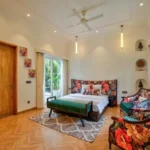 Neel Moira North Goa 5 BHK Luxury Master Bedroom With Floral Furniture And Balcony Access