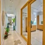 Neel Moira North Goa 5 BHK Interior Corridor With Wooden Doors And Glass Windows