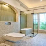 Neel Moira North Goa 5 BHK Bathroom With Glass Shower Area And Modern Toilet