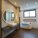 1 BHK 2 BHK La Wisteria Siolim North Goa Stylish Bathroom Interior With Jacuzzi Tub Round Mirror And Vanity Area