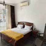 3 BHK Villa In Gondhalpada Alibaug Cozy Bedroom With Sliding Doors And Outdoor View