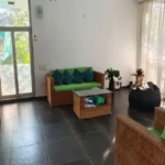 3 BHK Villa In Gondhalpada Alibaug Bright Living Room With Glass Doors And Seating