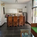 3 BHK Villa In Gondhalpada Alibaug Modern Kitchen With Bar Seating And Living Area