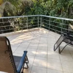 3 BHK Villa In Gondhalpada Alibaug Open Balcony With Outdoor Chairs And Green View