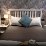 45 Saint Hills Riverfront Villas Khanand Karjat 3 BHK Premium Bedroom Setup With White Bedside Tables Cushions And Decorative Backdrop