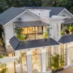 8 BHK Villa Luxe Riviera Candolim Goa Arched Glass Facade Dusk Lit Aerial Exterior