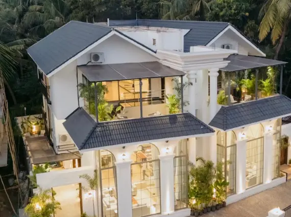 8 BHK Villa Luxe Riviera Candolim Goa Arched Glass Facade Dusk Lit Aerial Exterior