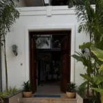 8 BHK Villa Luxe Riviera Candolim Goa Grand Wood Door Palm Lined White Facade Entrance