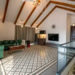 8 BHK Villa Luxe Riviera Candolim Goa Vaulted Beam Green Sofa Glass Railing Patterned Floor Lounge