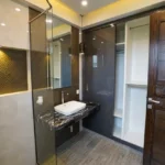Roswalt Zyon Oshiwara Andheri West 4 BHK Bathroom Interior With Glass Partition Vanity Counter Wooden Door