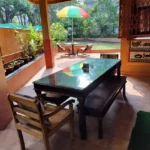Saudades Beach Bungalow Candolim Goa 3 BHK Glass Top Bench Seat Open Garden Dining