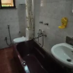 Saudades Beach Bungalow Candolim Goa 3 BHK Maroon Bathtub Tiled Wall Full Bathroom