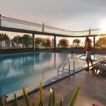 StarOm Ekya Marve Road Malad West Swimming Pool With Deck Seating Sunset View And Landscaped Surroundings