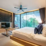 The Chapter Vaijali Alibaug 3 BHK Bedroom With Large Glass Windows Outdoor View And Modern Furniture