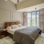3 BHK Bungalow Green Garden Chembur Mumbai Bedroom With Bed Side Table Large Window Curtains