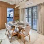 3 BHK Bungalow Green Garden Chembur Mumbai Dining Area With Marble Table Chairs Sliding Glass Doors Curtains