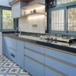 3 BHK Bungalow Green Garden Chembur Mumbai Kitchen With Blue Cabinets Gas Stove Countertop Shelving Window Ventilation