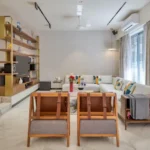 3 BHK Bungalow Green Garden Chembur Mumbai Living Room With Sofa Seating Wooden Chairs Center Table TV Unit