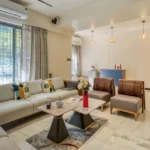 3 BHK Bungalow Green Garden Chembur Mumbai Living Room With Sofa Seating Armchairs Center Table Pendant Lights Window Curtains
