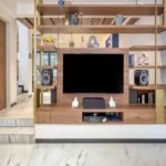 3 BHK Bungalow Green Garden Chembur Mumbai Living Room TV Wall Unit With Wooden Shelving Decorative Items Speakers