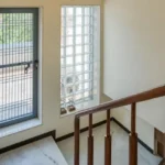 3 BHK Bungalow Green Garden Chembur Mumbai Staircase Area With Wooden Handrail Marble Flooring Tall Window Glass