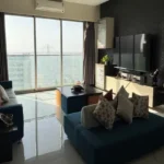 3 BHK Tranquil Bay Prabhadevi Teal Blue Sectional Dark Textured Wall Bandra Worli Sealink View Living Room