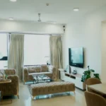 4 BHK Lodha Marquise Lower Parel Tufted Sofa Glass Coffee Table Beige Curtain Open Plan Living Room