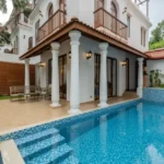 4 BHK Villas Elements Nachinola Goa luxury villa exterior with private swimming pool arched balconies outdoor lighting
