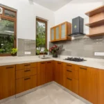 4 BHK Villas Elements Nachinola Goa modular kitchen with wooden cabinets gas cooktop chimney