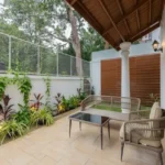 4 BHK Villas Elements Nachinola Goa private garden patio area with outdoor seating landscaped plants tiled flooring
