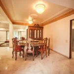6 BHK Villa Clover Hills Kondhwa Pune Formal Dining Area With Wooden Furniture And Chandelier