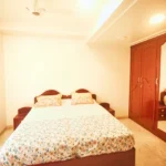 6 BHK Villa Clover Hills Kondhwa Pune Minimal Bedroom Interior With Wooden Storage Wardrobe