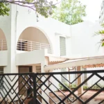 6 BHK Villa Clover Hills Kondhwa Pune Modern White Villa Exterior With Arched Balcony Entrance