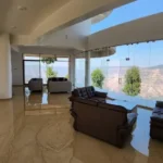 7 BHK Villa Panchgani Mahabaleshwar Interior Double Height Living Area With Sofa Seating Large Glass Walls Valley View