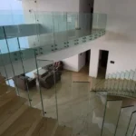 7 BHK Villa Panchgani Mahabaleshwar Interior Mezzanine Floor View With Glass Railing Overlooking Living Area Staircase