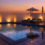 Asopalav Kandivali West rooftop infinity pool with poolside loungers sunset sky lighting features