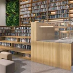 Isle Of Calm Powai library lounge with floor to ceiling bookshelves, wooden interiors and reading spaces