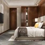 Kolte Patil Verve Bangur Nagar Goregaon West 3 BHK Master Bedroom Interior With Wooden Wardrobe Paneling Upholstered Bed Side Table Lighting False Ceiling Design