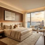 La Mer Mumbai Central 3 BHK Bedroom With Wooden Accent Wall Plush Upholstered Bed Ambient Lighting And Coastal Skyline View